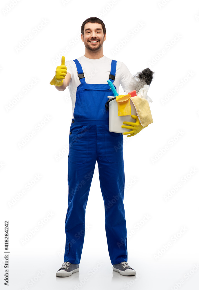 profession, service and people - happy smiling male worker or cleaner in overal and gloves with cleaning supplies showing thumbs up over white background profession, service and people - happy smiling male worker or cleaner in overal and gloves with cleaning supplies showing thumbs up over white background