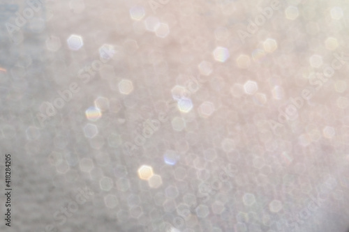 Sequins in defocus. A background of blurry water droplets at high magnification. Macro shooting. Fuzzy boundaries. Place for text