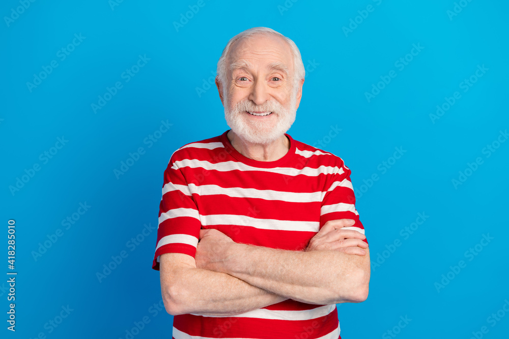Fototapeta premium Photo of optimistic old grey hairdo man crossed arms wear red t-shirt isolated on bright blue color background