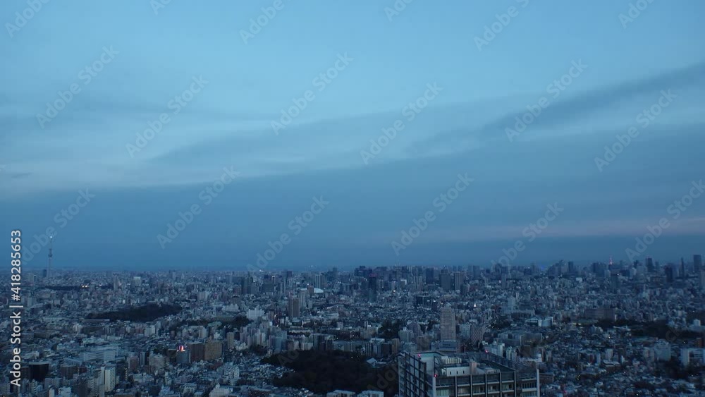 TOKYO, JAPAN : Aerial high angle sunset CITYSCAPE of TOKYO. View of buildings at central downtown area. Japanese city life and urban metropolis concept. Long time lapse zoom out shot, dusk to night. TOKYO, JAPAN : Aerial high angle sunset CITYSCAPE of TOKYO. View of buildings at central downtown area. Japanese city life and urban metropolis concept. Long time lapse zoom out shot, dusk to night.