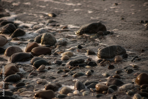 Sea shore with stones and foam, pebble seascape.  © MadCat13Shoombrat