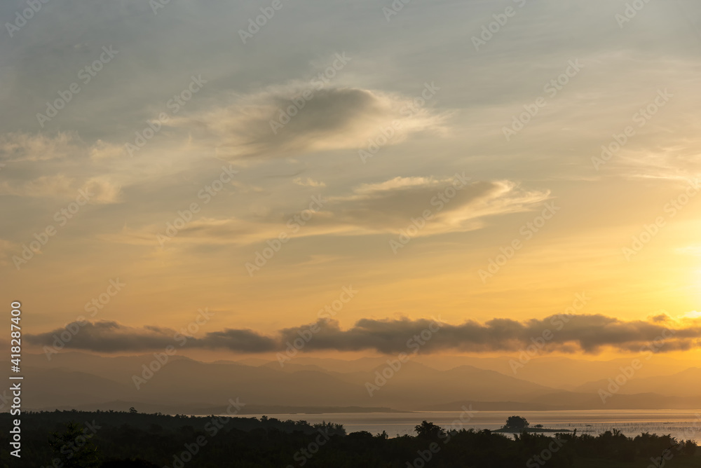 Beautiful scenery with clouds during sunrise with mountain view as background. Beautiful scenery with clouds during sunrise with mountain view as background.