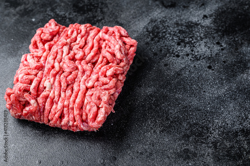 Raw mince beef  ground meat. Black background. Top view. Copy space