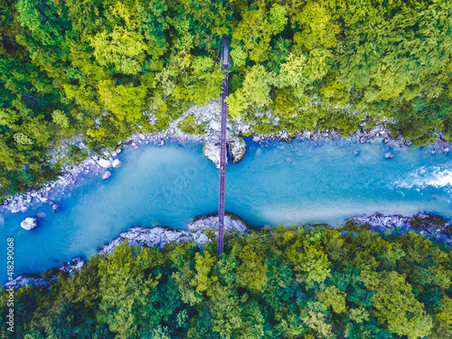 Aerial view of the turquoise blue Soca river and wooden bridge near Bovec in the Julian Alps in Slovenia photo