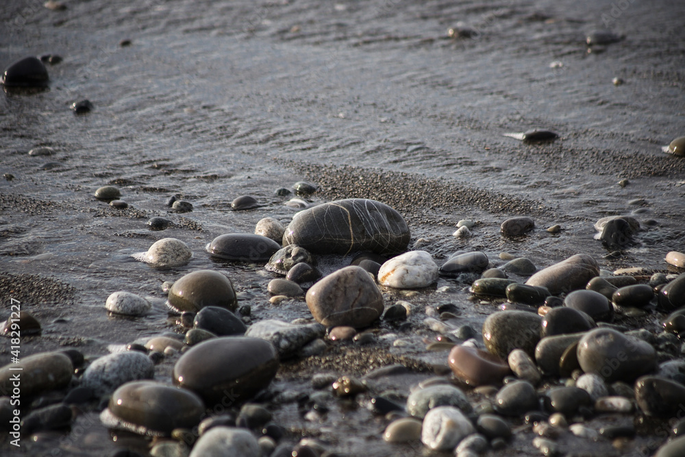 Sea shore with stones and foam, pebble seascape. Sea shore with stones and foam, pebble seascape.