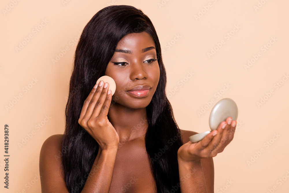 Photo of tender flawless lovely lady hold cotton disc sponge look little mirror isolated beige background Photo of tender flawless lovely lady hold cotton disc sponge look little mirror isolated beige background