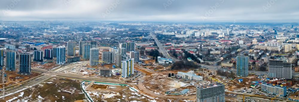 Panoramic view of construction of high-rise resedential buildings. The construction industry with working equipment. View from above. Eye bird view of new resedential district.