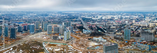 Panoramic view of construction of high-rise resedential buildings. The construction industry with working equipment. View from above. Eye bird view of new resedential district. photo