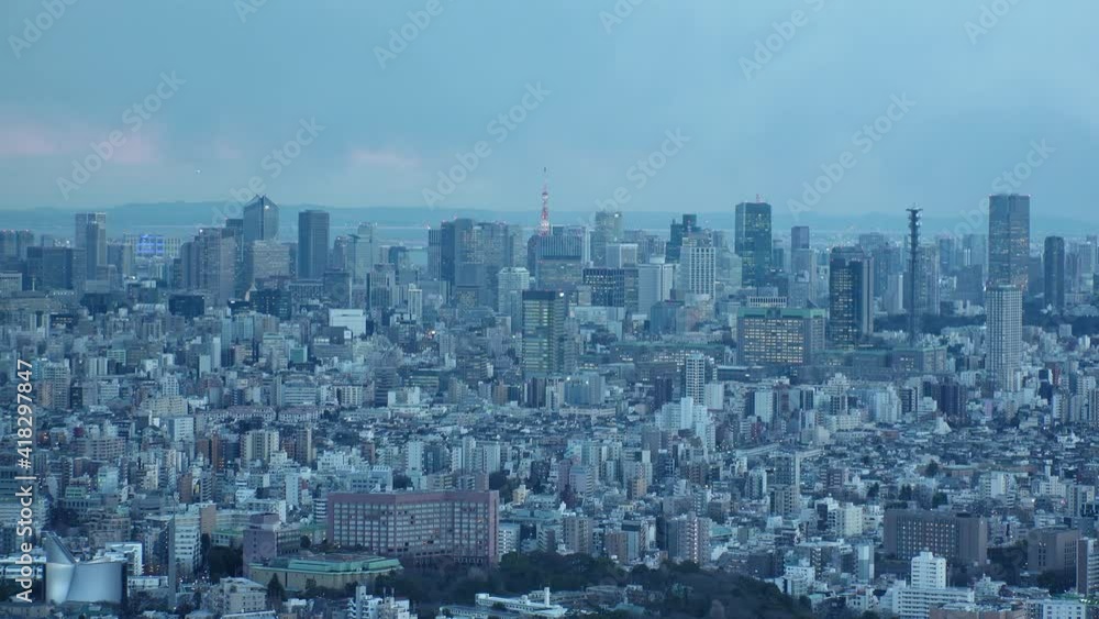 TOKYO, JAPAN : Aerial high angle sunset CITYSCAPE of TOKYO. View of office buildings around crowded downtown area. Japanese business and urban metropolis concept. Long time lapse shot dusk to night. TOKYO, JAPAN : Aerial high angle sunset CITYSCAPE of TOKYO. View of office buildings around crowded downtown area. Japanese business and urban metropolis concept. Long time lapse shot dusk to night.