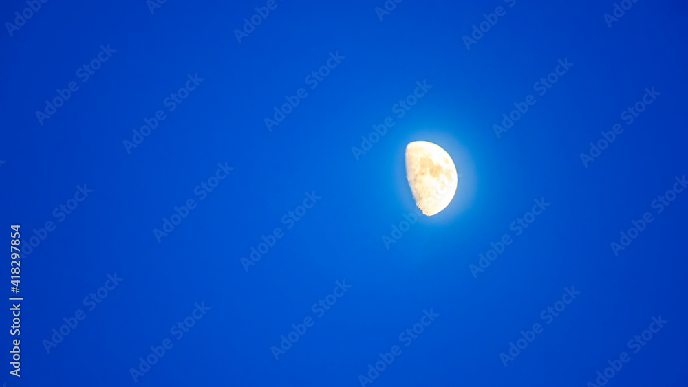 Crescent in the blue evening cloudless sky. Moon in the sky. Design concept. Space for text. Crescent in the blue evening cloudless sky. Moon in the sky. Design concept. Space for text.