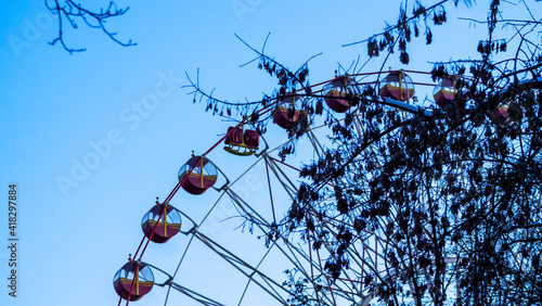 Fototapeta Naklejka Na Ścianę i Meble -  Close up some part of Ferris Wheel at evening time. Big observation wheel on the dark blue sky background. Holiday concept.