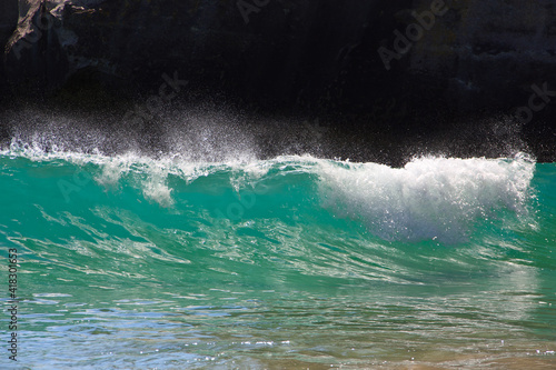 Waves on sandy beach in New Zealand