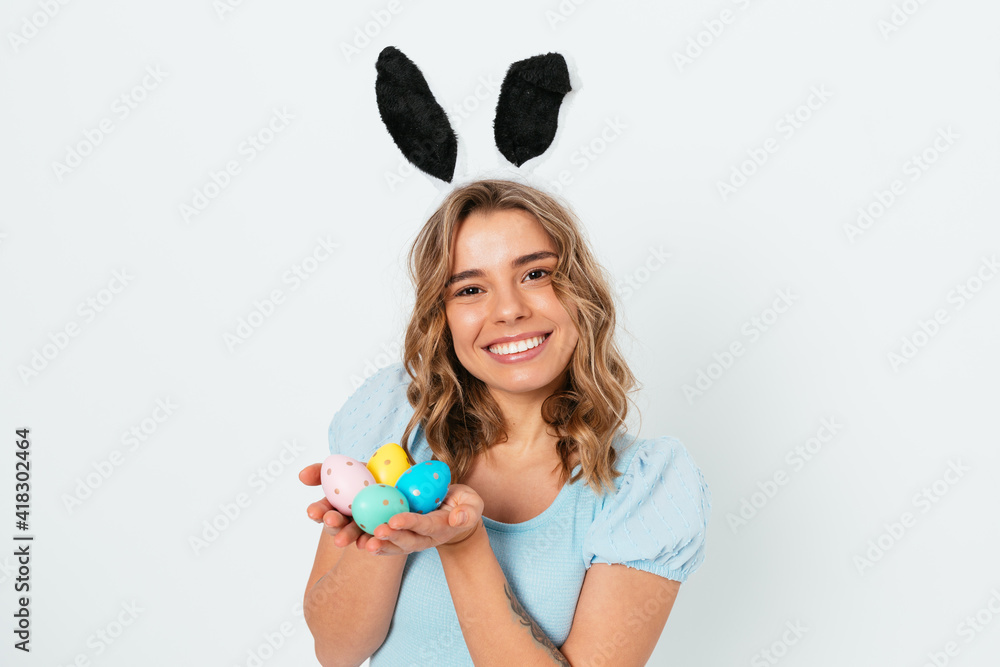 Happy Easter celebration, cute smiling young woman wearing bunny ears Happy Easter celebration, cute smiling young woman wearing bunny ears
