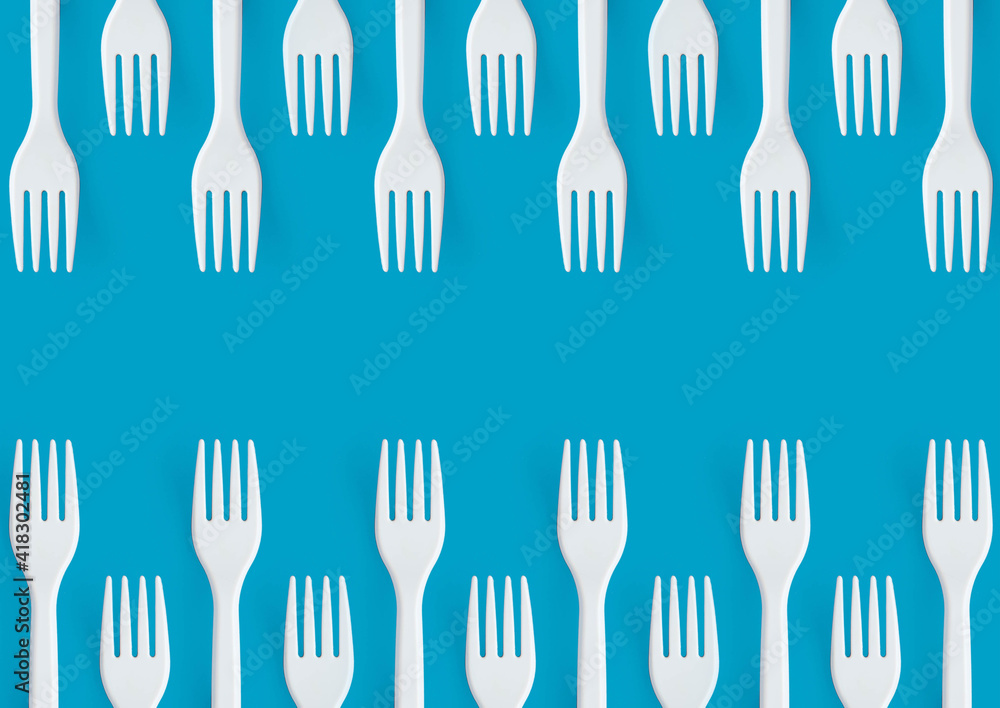 Pattern of white forks on blue background. Creative and modern concept with copy space. Pattern of white forks on blue background. Creative and modern concept with copy space.