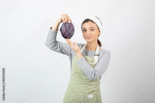 Picture of positive woman posing with purple cabbage on white background