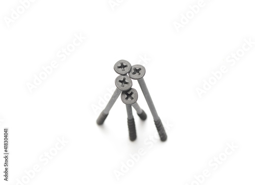 metal screws with long dark thread on white background