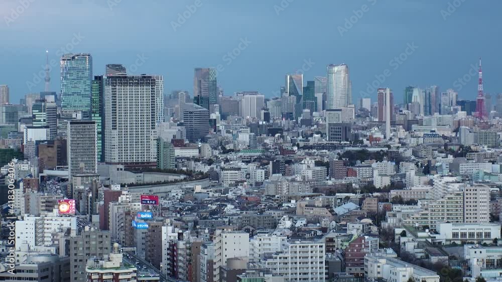 TOKYO, JAPAN : Aerial high angle sunset CITYSCAPE of TOKYO. View of buildings and streets at central downtown area. Japanese city life and metropolis concept. Time lapse tracking shot dusk to night. TOKYO, JAPAN : Aerial high angle sunset CITYSCAPE of TOKYO. View of buildings and streets at central downtown area. Japanese city life and metropolis concept. Time lapse tracking shot dusk to night.