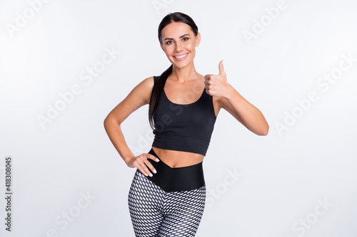 Photo of happy smiling beautiful sportive athlete woman showing thumb-up like isolated on white color background