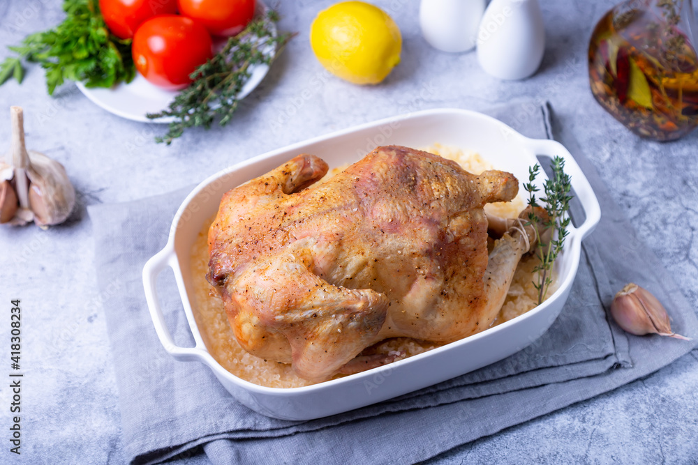 Whole baked chicken in sea salt. Home cuisine, traditional dish. Close-up. Whole baked chicken in sea salt. Home cuisine, traditional dish. Close-up.