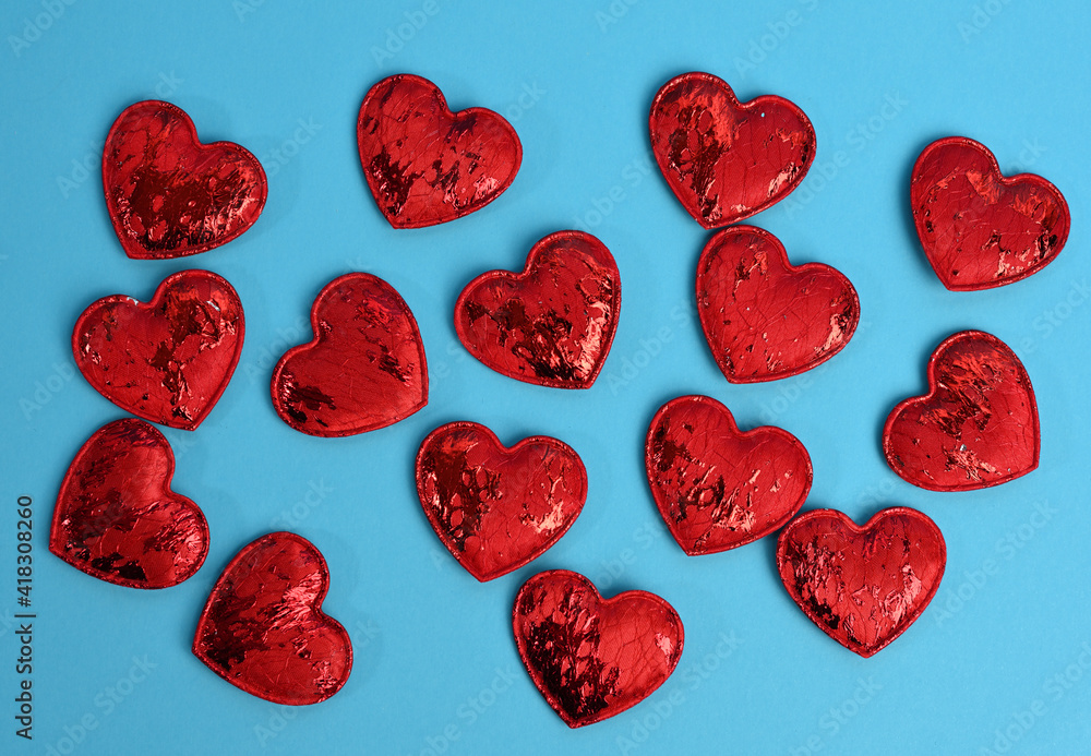 Fototapeta premium red textile small hearts on blue background, festive background