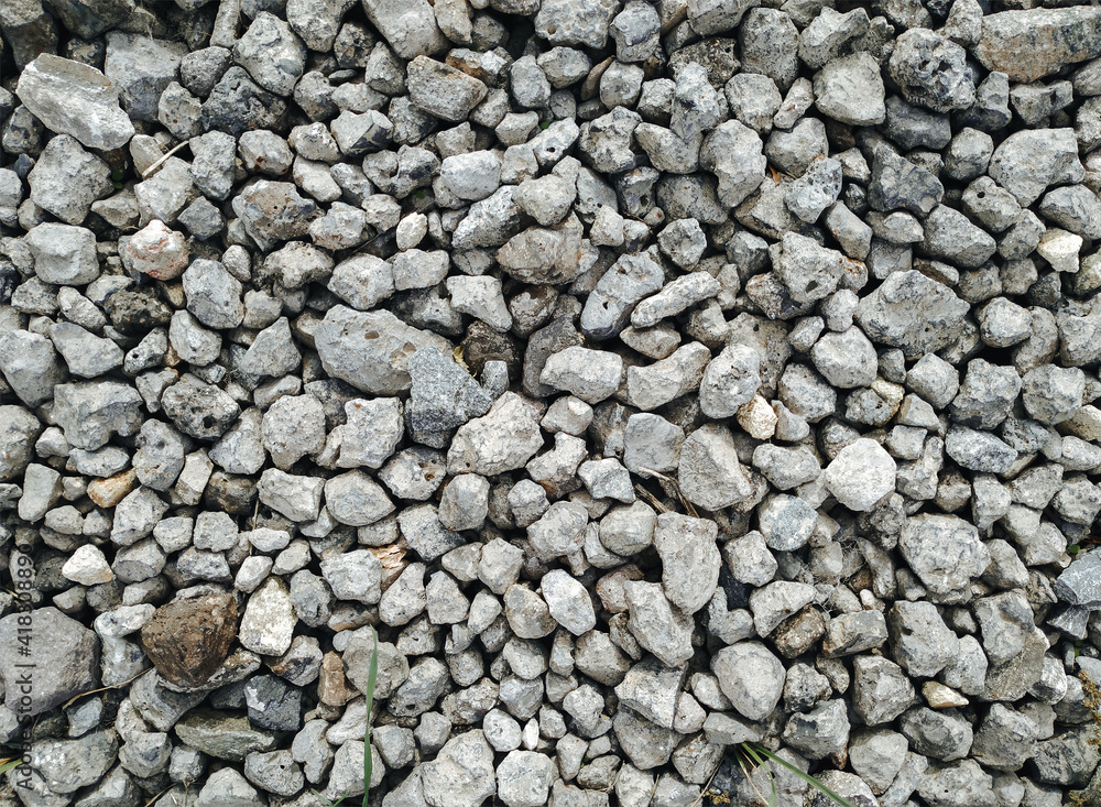 Slag in the form of small gray stones close-up. Waste rock during iron ore mining. Top view, copy space. Slag in the form of small gray stones close-up. Waste rock during iron ore mining. Top view, copy space.