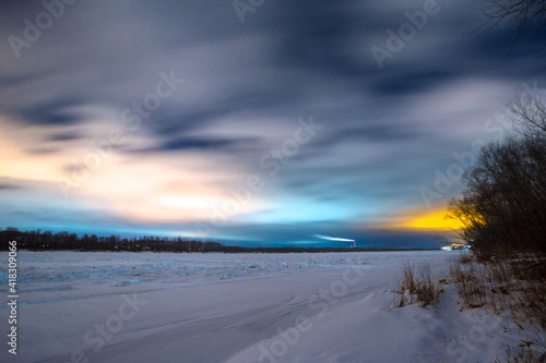 sunset over the river in winter in Omsk