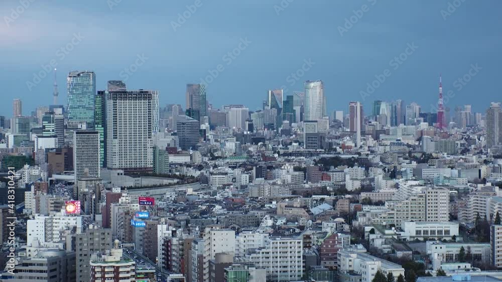 TOKYO, JAPAN : Aerial high angle sunset CITYSCAPE of TOKYO. View of buildings and streets at central downtown area. Japanese city life and metropolis concept. Time lapse zoom in shot dusk to night. TOKYO, JAPAN : Aerial high angle sunset CITYSCAPE of TOKYO. View of buildings and streets at central downtown area. Japanese city life and metropolis concept. Time lapse zoom in shot dusk to night.