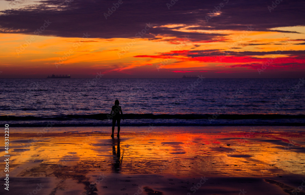 Woman enjoying the sunset at fuente bravia beach in el puerto de santa maria cadiz 