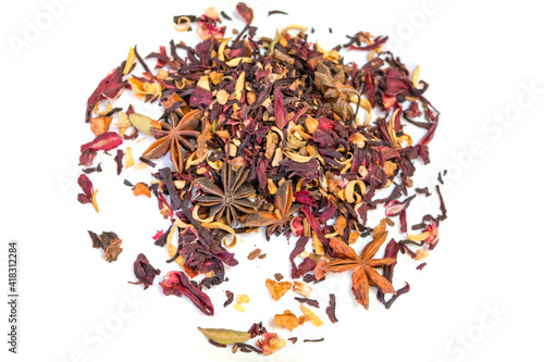 Heap of dry herbal tea with spices and fruits (hibiscus, star anise and other) on white background