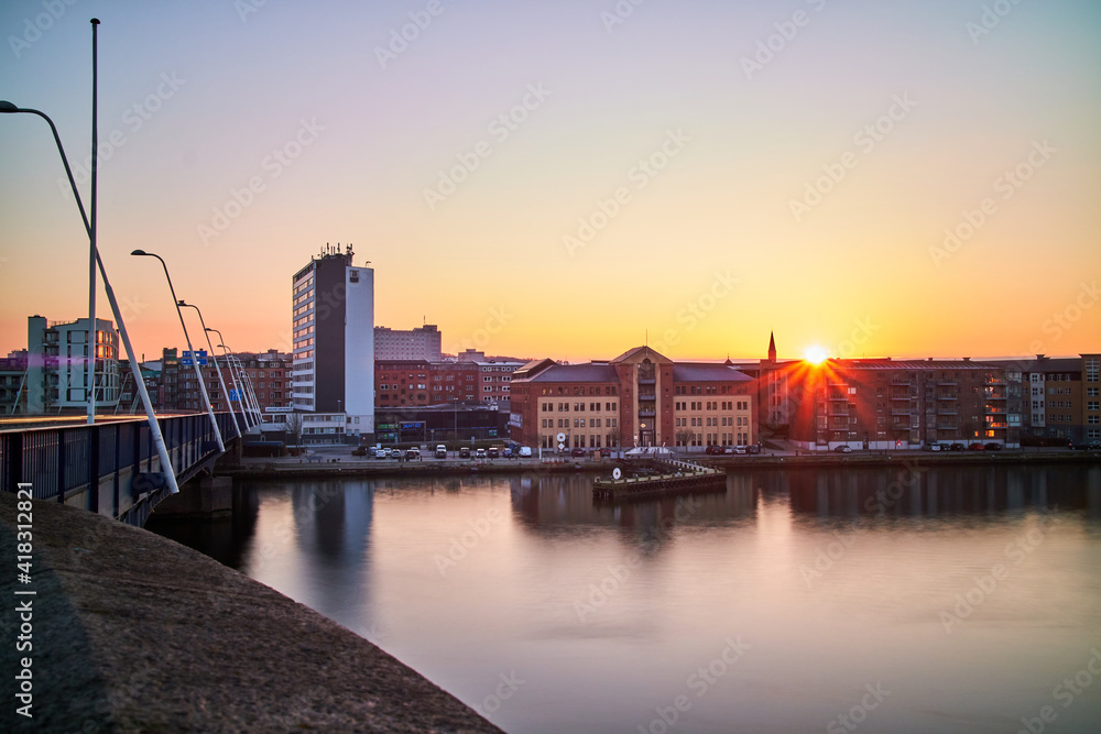 city view with sunset and a bridge and buildings
