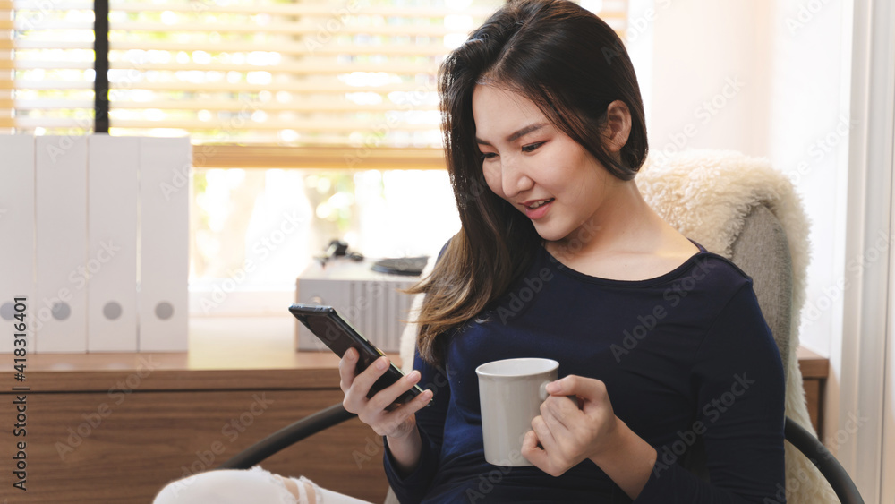 asian woman using mobile phone at home Communication and coziness concept. asian woman using mobile phone at home Communication and coziness concept.