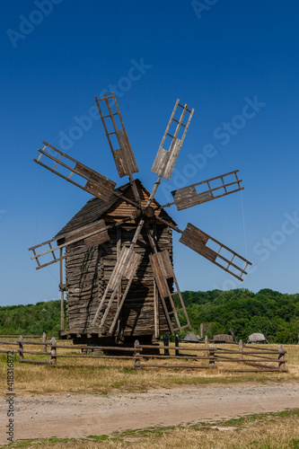 Old windmill on blue sky background