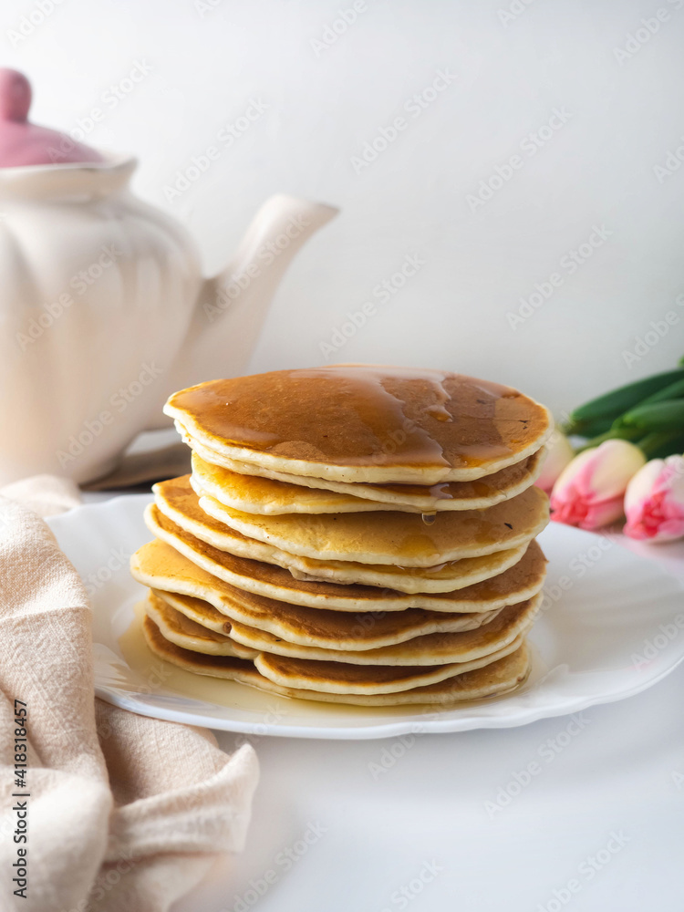 A stack of pancakes with honey