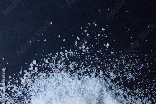 spilled salt on a dark background © Mariia