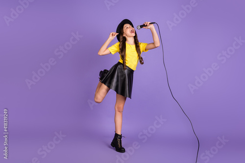 Full size photo of nice optimistic brunette hairdo girl sing in mic wear cap t-shirt skirt isolated on lilac background