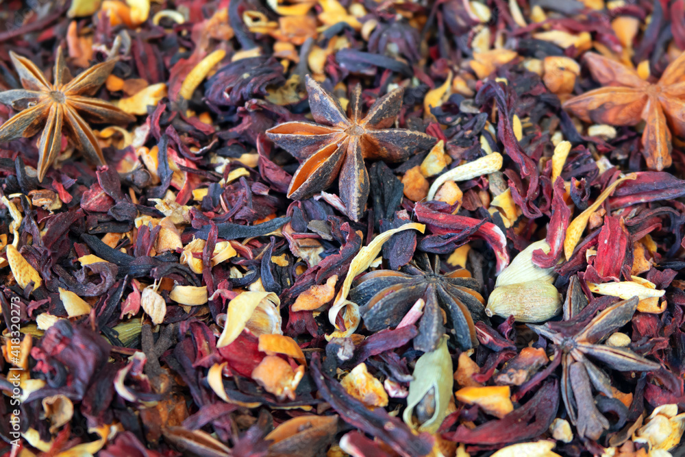 Texture of dry herbal tea with spices and fruits (hibiscus, star anise and other). Soft focus around the edges of the image Texture of dry herbal tea with spices and fruits (hibiscus, star anise and other). Soft focus around the edges of the image