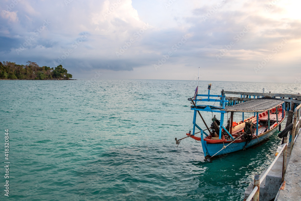 an asian adult standing on his fishing boat to start work day on morning at the island driving for people as a taxi an asian adult standing on his fishing boat to start work day on morning at the island driving for people as a taxi