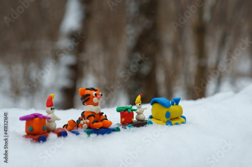 Toy train made of plasticine in the winter forest.