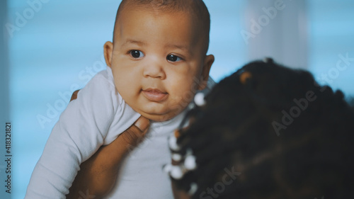 Happy family concept. Young african american black father holding his baby. High quality photo