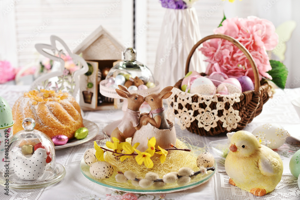 Easter table decoration with kissing bunny figurines on the plate Easter table decoration with kissing bunny figurines on the plate