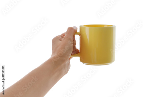 Woman holding elegant yellow cup on white background, closeup