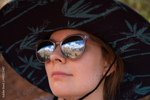 Close-up portrait of girl with glasses reflecting Zion National Park mountains