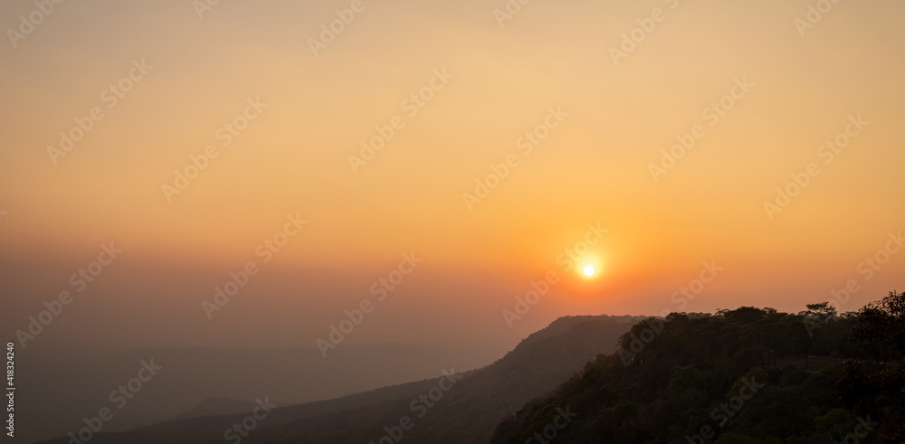 Panoramic beautiful sunset landscape from the pine forest in the national park on top mountain, Thailand.
