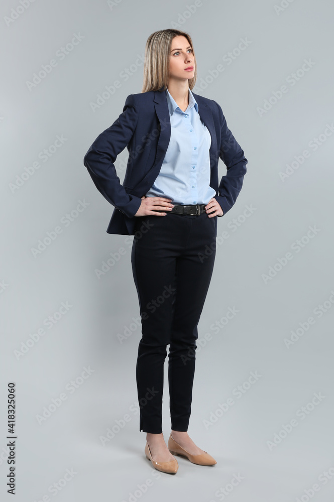 Full length portrait of young woman on grey background Full length portrait of young woman on grey background