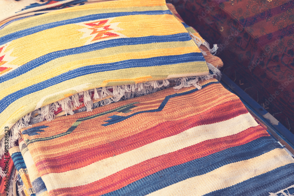 Stack of Caucasian and Oriental carpets represented in a local Turkey bazaar shop. Istanbul, Turkey Stack of Caucasian and Oriental carpets represented in a local Turkey bazaar shop. Istanbul, Turkey