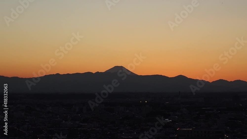 Wallpaper Mural TOKYO, JAPAN : Aerial high angle sunset CITYSCAPE of TOKYO and MOUNT FUJI. View of sinking sun and buildings. Japanese urban city life and metropolis concept. Time lapse tracking shot dusk to night. Torontodigital.ca