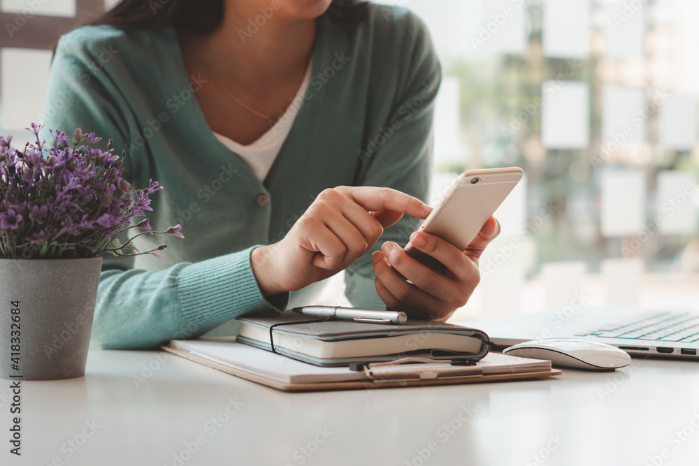 Fototapeta premium Women work at home and use smartphones and laptops to communicate, surf the internet or shop online, work from home concept.