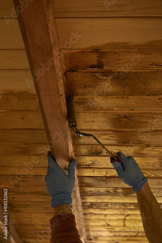 Wallpaper Mural Builder worker painting a house. DIY concept. Focus on roller. Torontodigital.ca