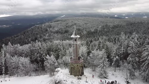 Tall lookout tower Stepanka in Jizerske Hory, Czech republic. Drone footage shot in very cold weather in winter. Aerial HD footage. photo