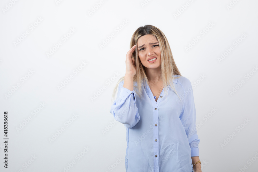 Image of blonde woman looking at camera on white background Image of blonde woman looking at camera on white background
